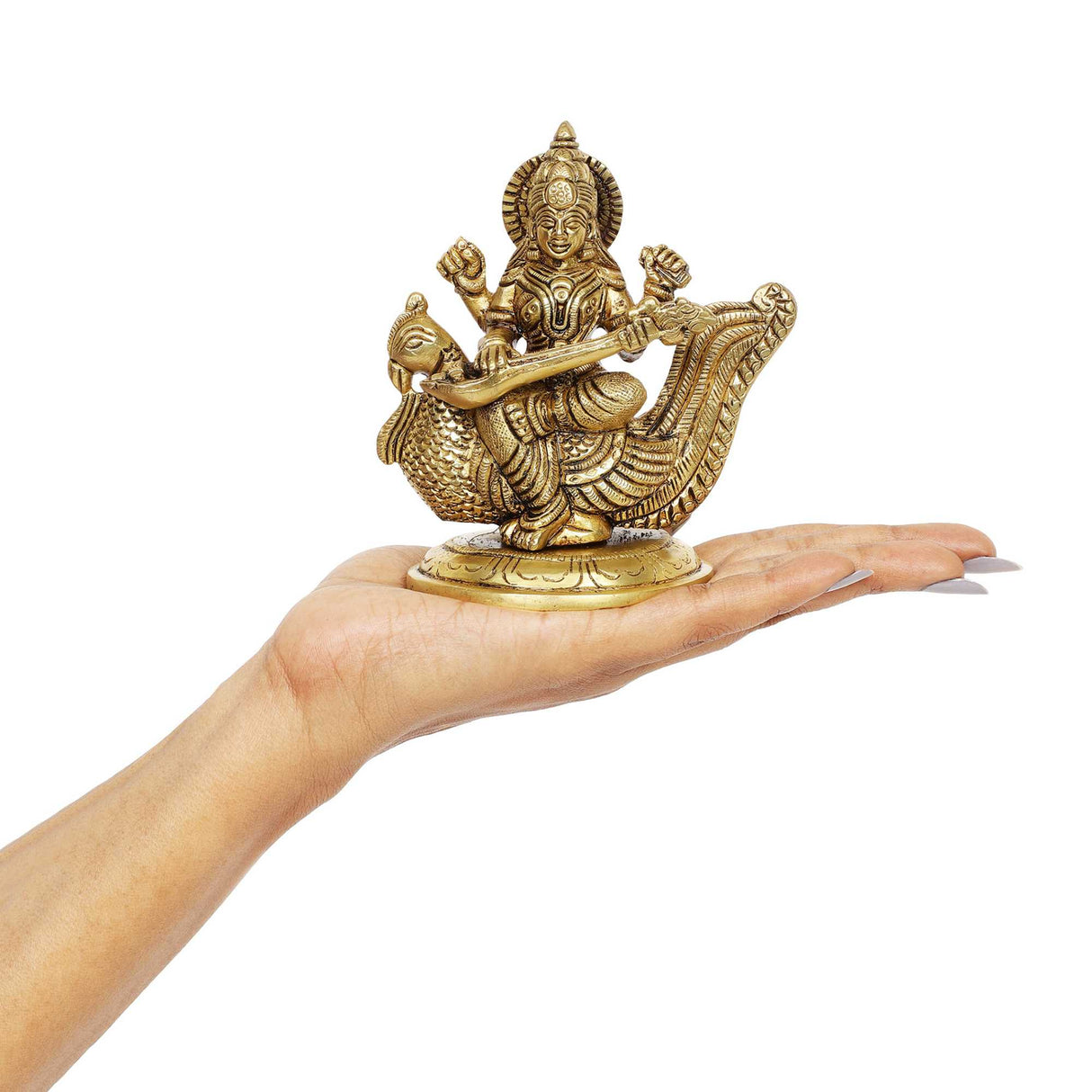 A hand holding  a Saraswati idol 