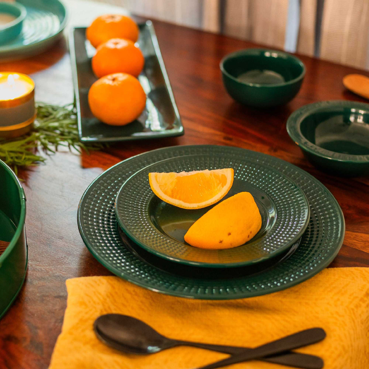 Dinner table setting with green ceramic plate