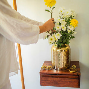 Gold metal vase with flowers